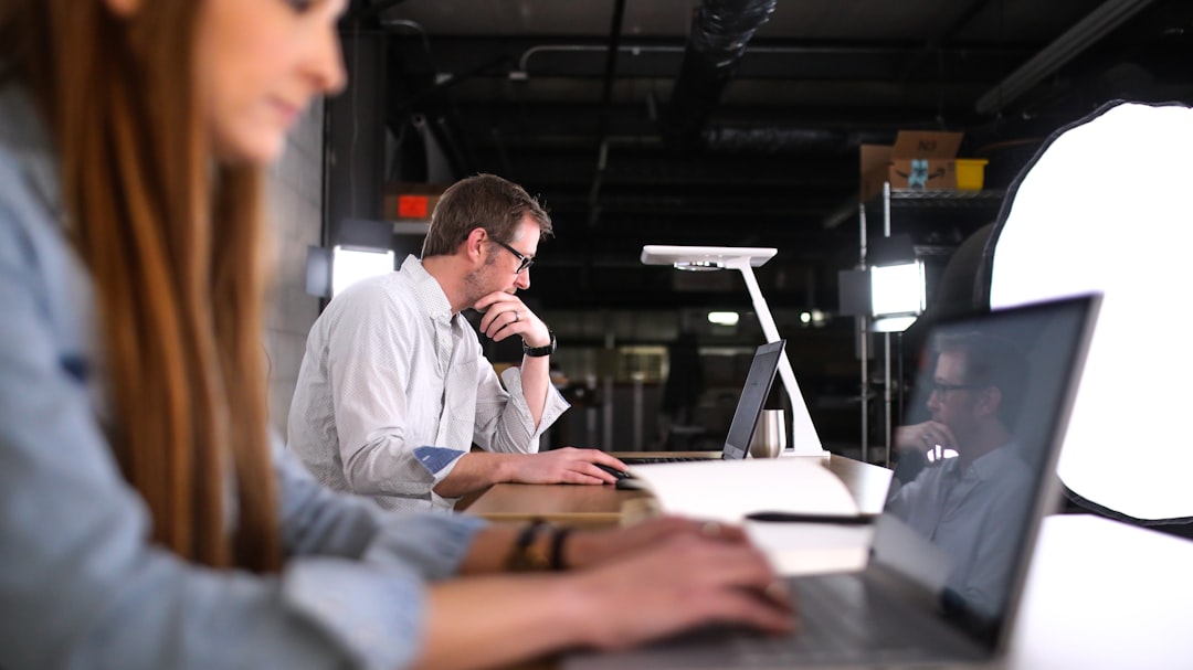 man in white dress shirt sitting beside man in white dress shirt - Photo by TheStandingDesk on Unsplash