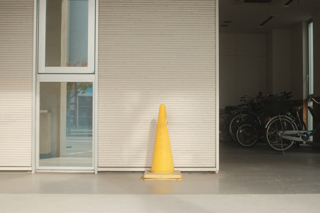 a yellow cone sitting in front of a building - Photo by Mak on Unsplash