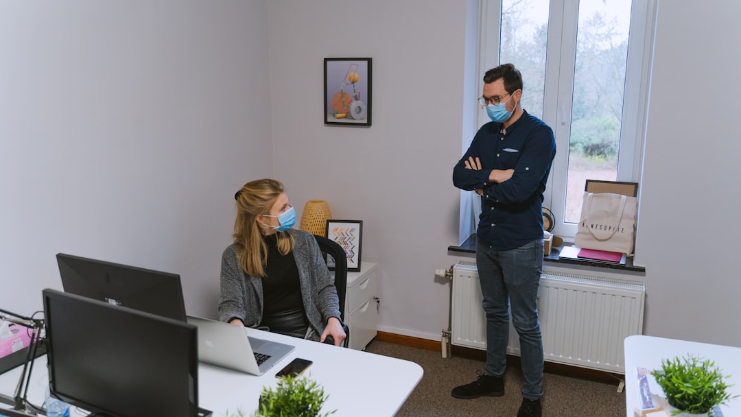 woman in black long sleeve shirt standing beside woman in gray long sleeve shirt - Photo by Maxime on Unsplash