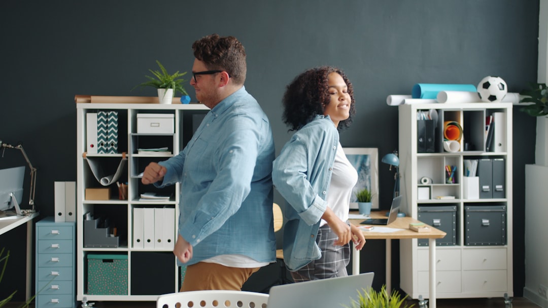 Man and woman back to back in office - Photo by Vitaly Gariev on Unsplash