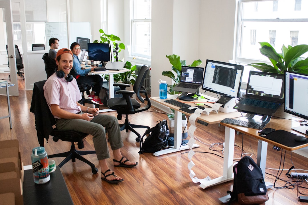 man in blue dress shirt sitting on black office rolling chair - Photo by David Schultz on Unsplash
