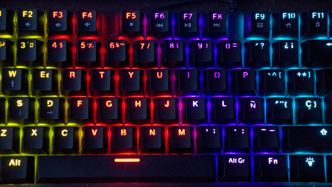 Close-up of an RGB backlit mechanical keyboard with colorful gradient lighting